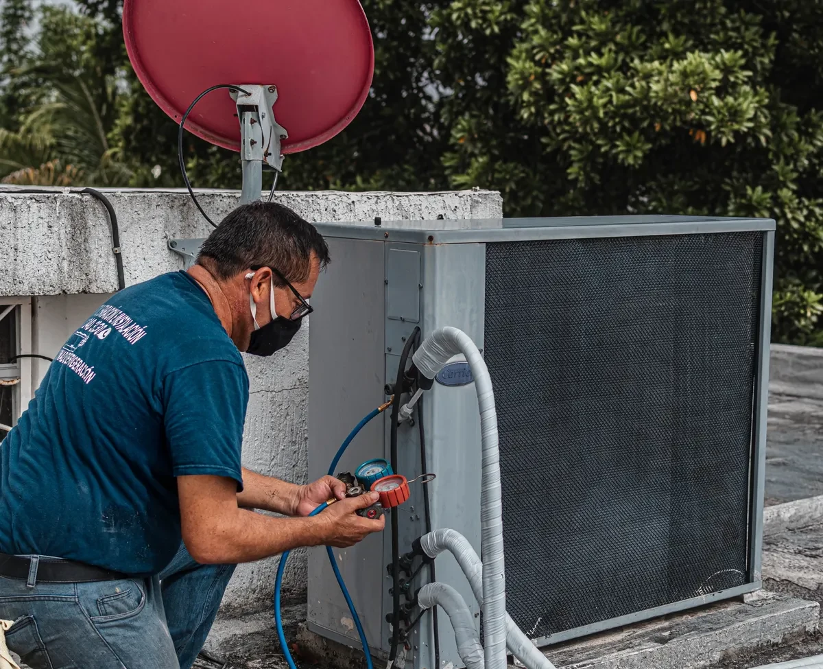 HVAC technician servicing commercial equipment